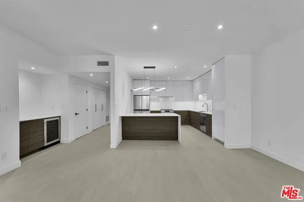 a large kitchen with a large counter top appliances and cabinets