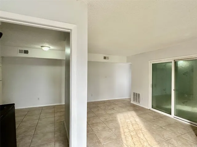 a view of an empty room with glass door