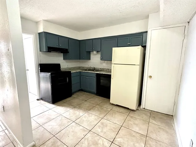a kitchen with stainless steel appliances a refrigerator sink and cabinets