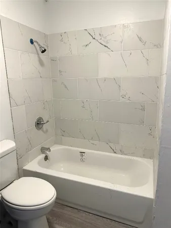 a white bath tub sitting next to a white toilet