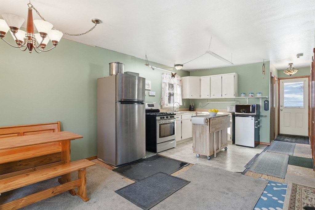 200 Fox Den Road Tolland, MA 01034 - Photo 16 of 37 a kitchen with white cabinets and stainless steel appliances