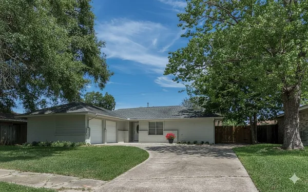 a front view of a house with a yard and a garage