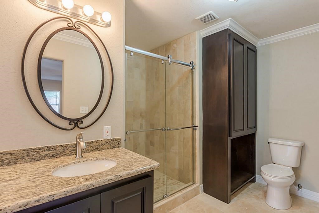 6514 Reamer Street Houston, TX 77074 - Photo 12 of 19 a bathroom with a granite countertop sink toilet and a mirror