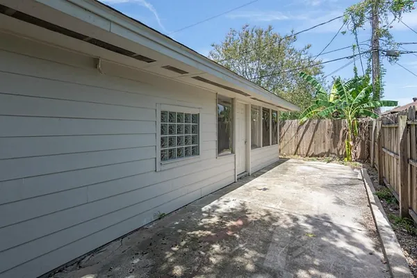 a view of house with backyard and wooden fence