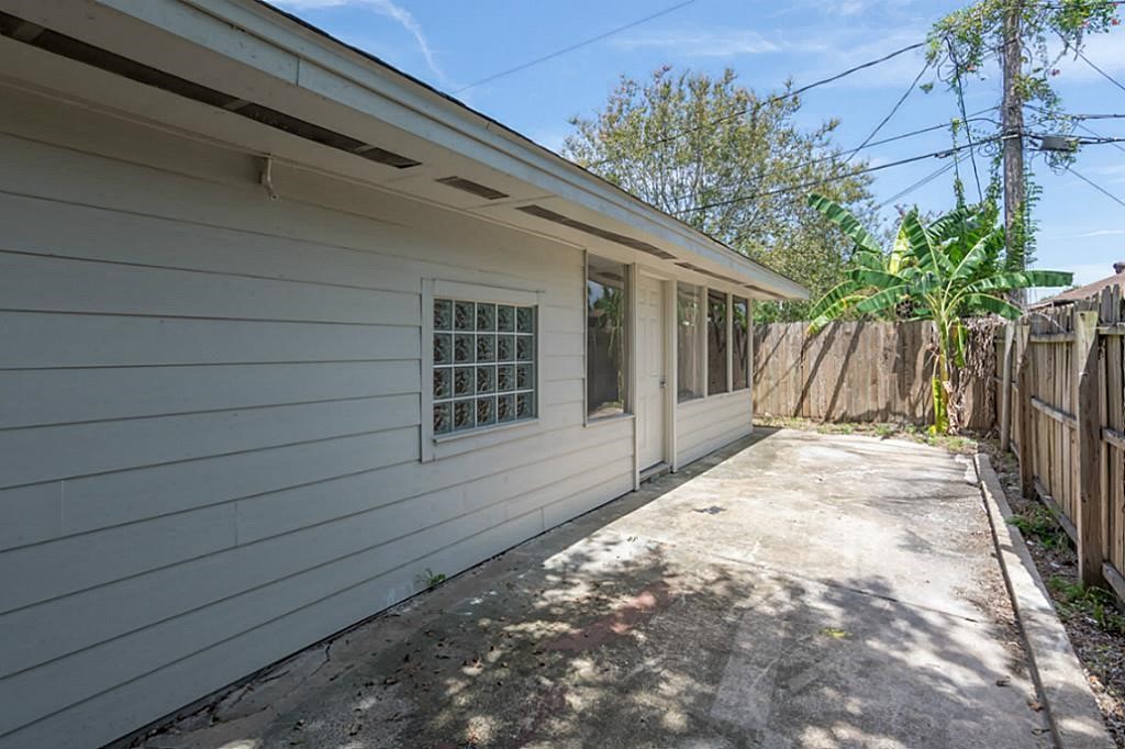 6514 Reamer Street Houston, TX 77074 - Photo 19 of 19 a view of house with backyard and wooden fence