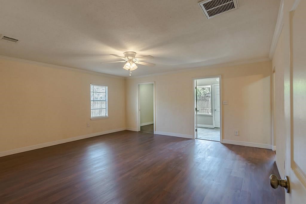 6514 Reamer Street Houston, TX 77074 - Photo 3 of 19 a view of an empty room with a window and wooden floor