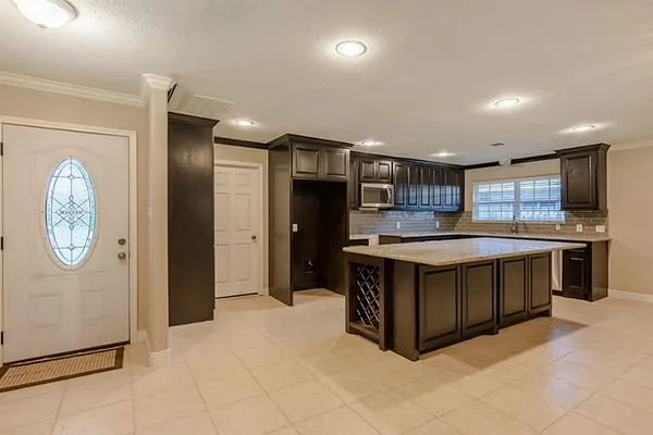 a kitchen with stainless steel appliances granite countertop a refrigerator and a stove