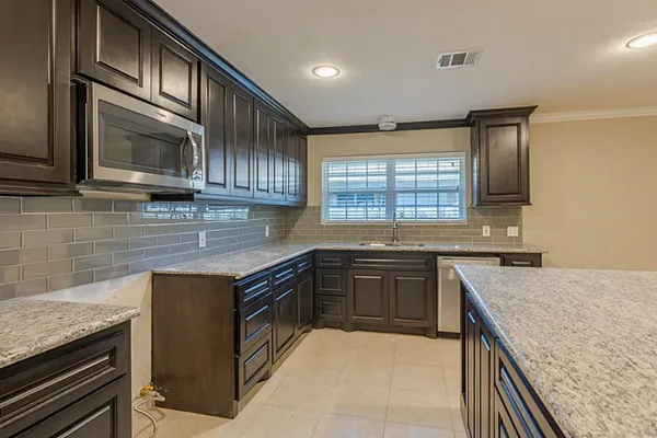 a kitchen with stainless steel appliances granite countertop stove microwave and sink