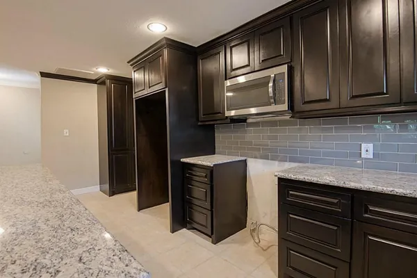 a kitchen with stainless steel appliances granite countertop cabinets and window
