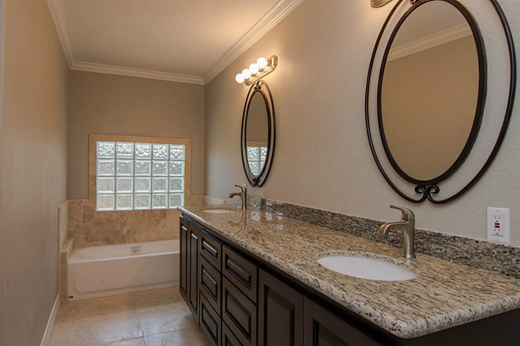 6514 Reamer Street Houston, TX 77074 - Photo 10 of 19 a bathroom with a granite countertop sink and a mirror