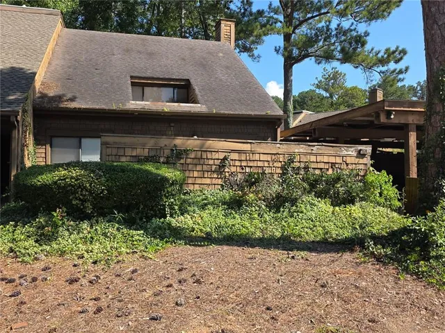 a aerial view of a house with a yard and potted plants