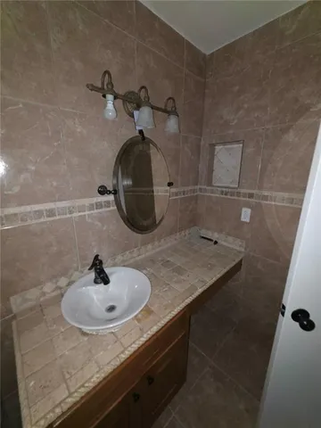 a bathroom with a sink and mirror