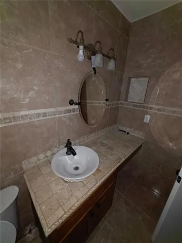 a bathroom with a sink and vanity