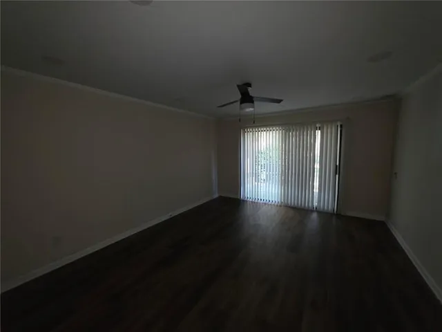 a view of wooden floor and windows in a room