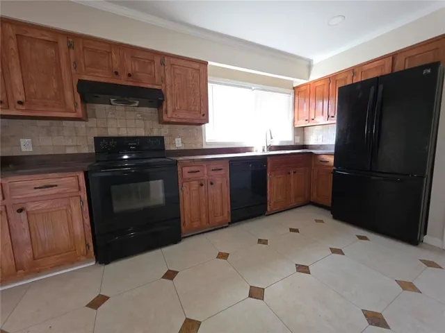 a kitchen with stainless steel appliances granite countertop a refrigerator sink and cabinets