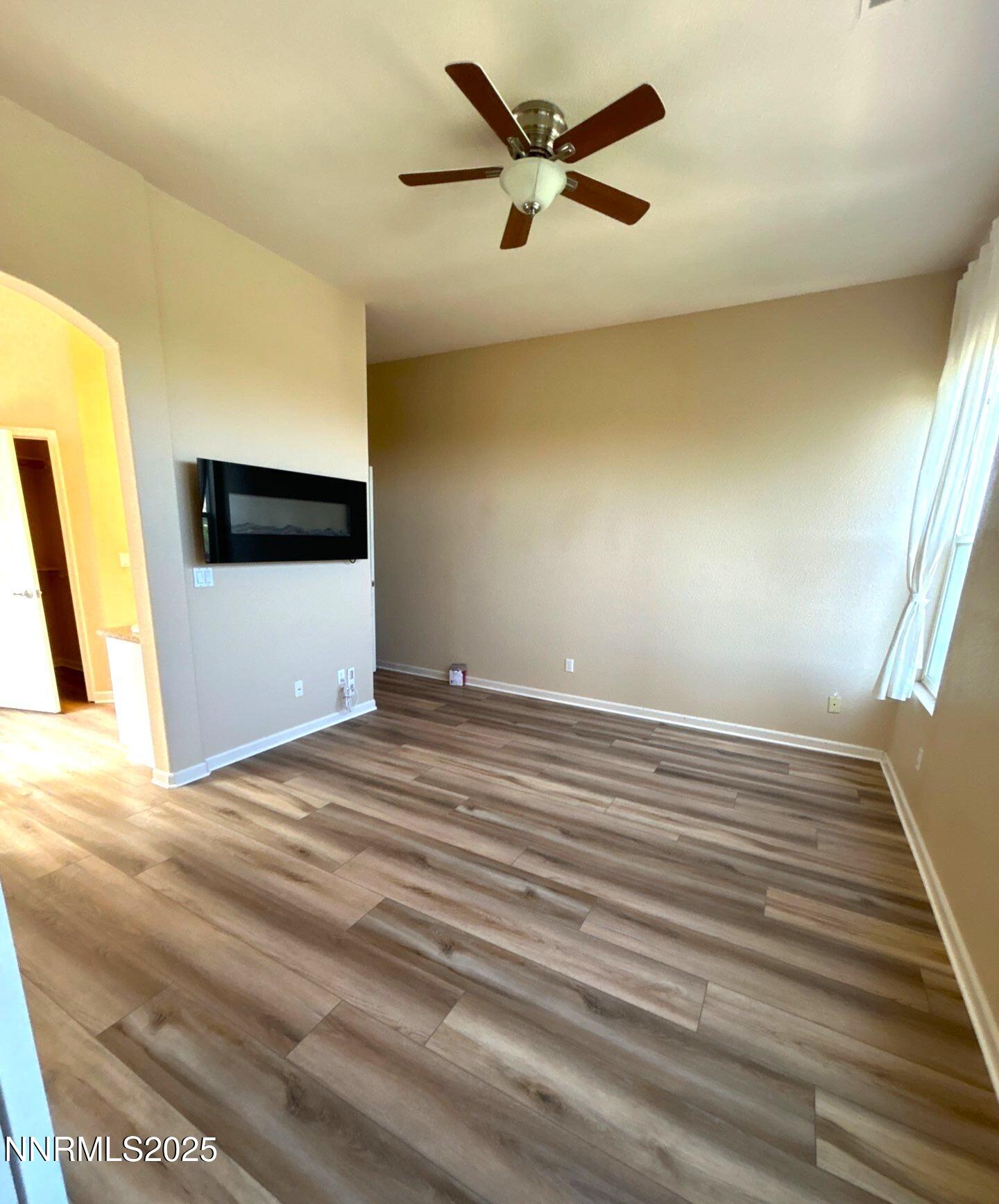1484 Cloud Peak Drive Sparks, NV 89436 - Photo 11 of 16 a view of a livingroom with wooden floor and a ceiling fan