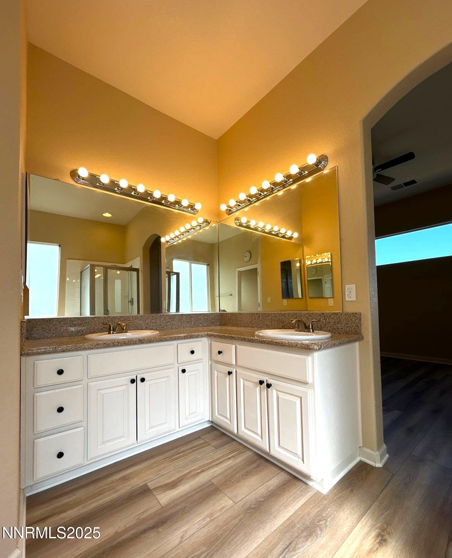 1484 Cloud Peak Drive Sparks, NV 89436 - Photo 12 of 16 a bathroom with a sink and a large mirror