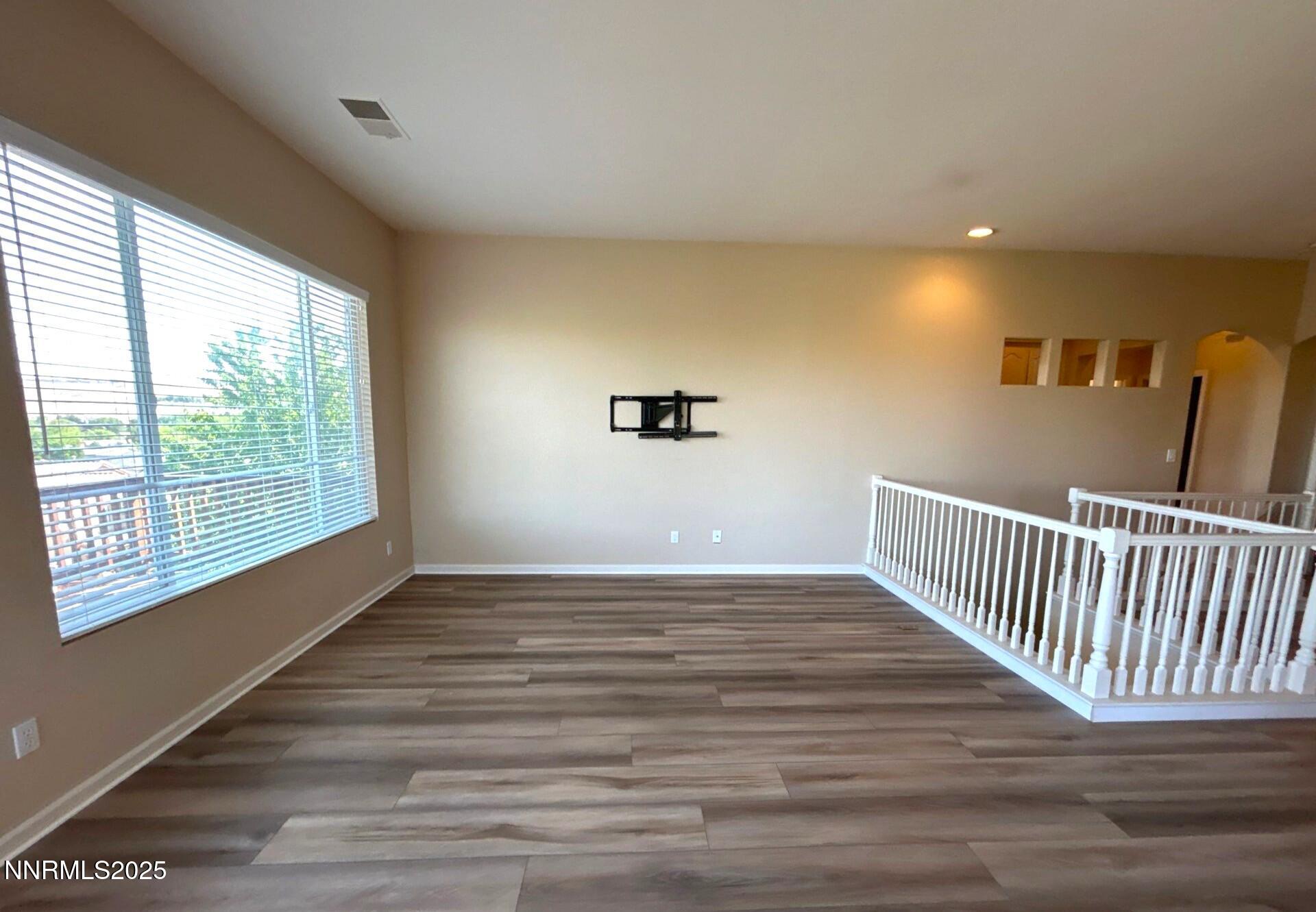 1484 Cloud Peak Drive Sparks, NV 89436 - Photo 4 of 16 a view of an empty room with wooden floor and a window