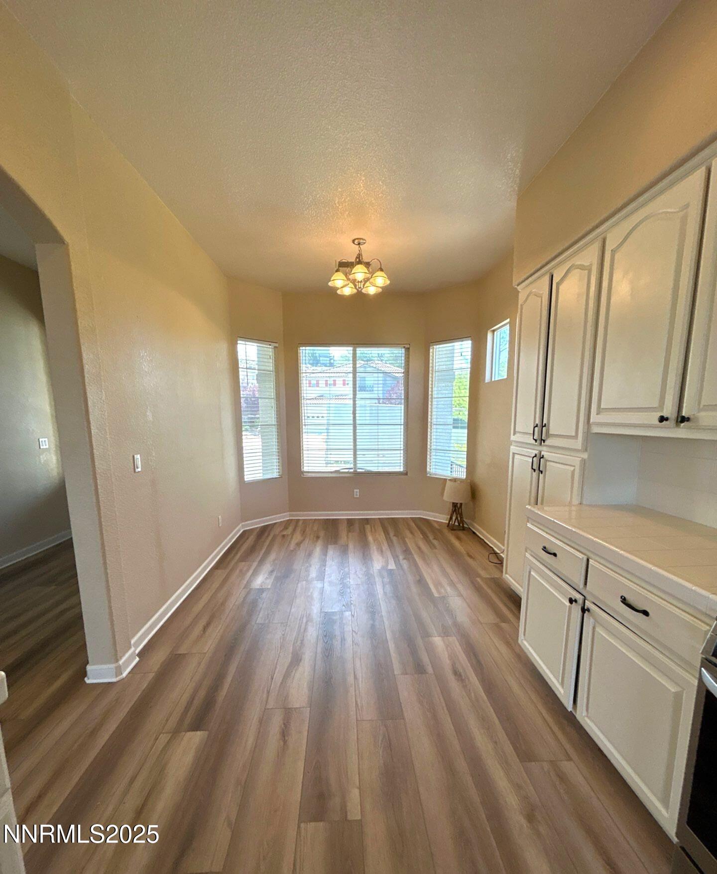 1484 Cloud Peak Drive Sparks, NV 89436 - Photo 6 of 16 wooden floor in an empty room with a window