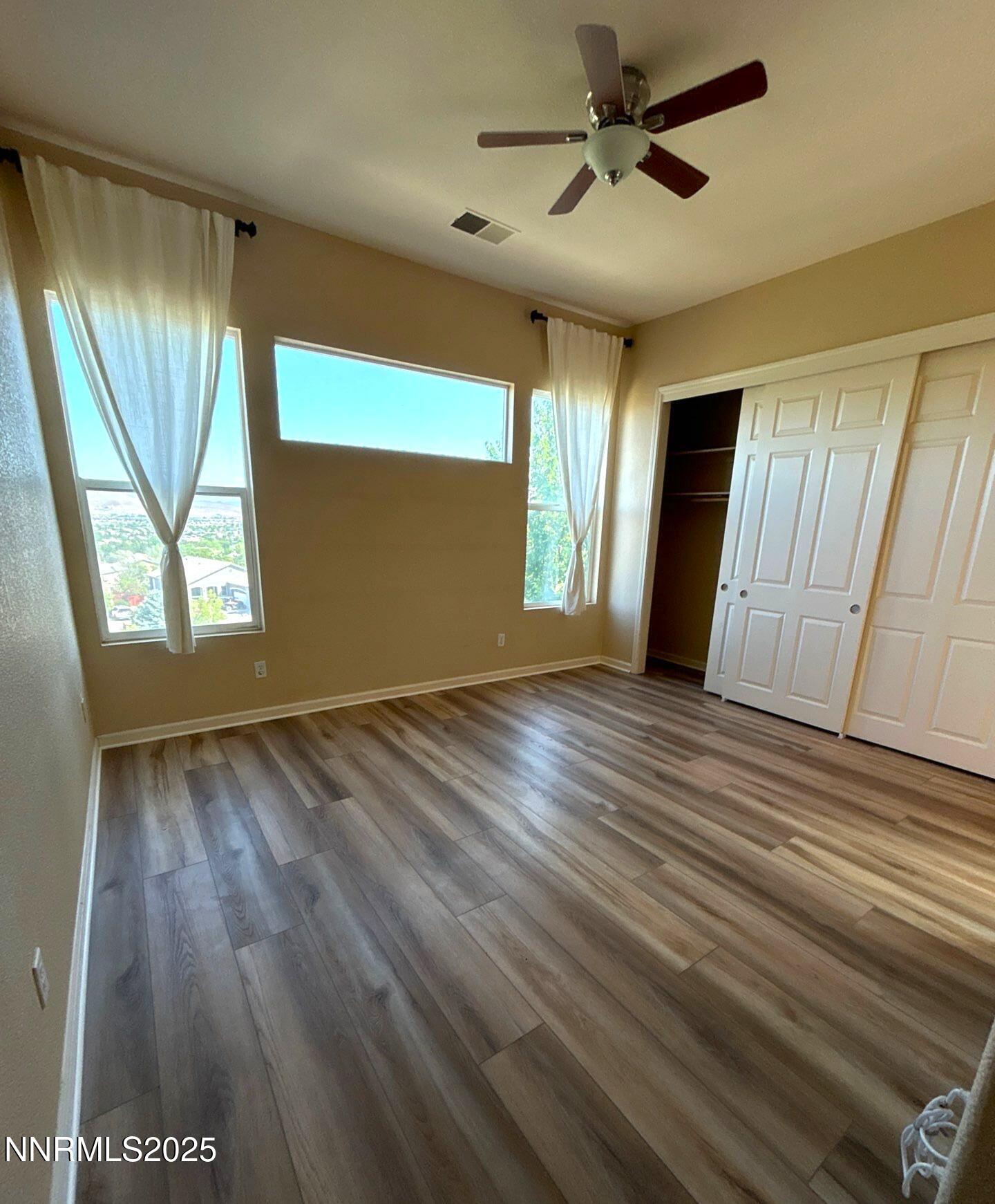 1484 Cloud Peak Drive Sparks, NV 89436 - Photo 10 of 16 a view of an empty room with a window and wooden floor