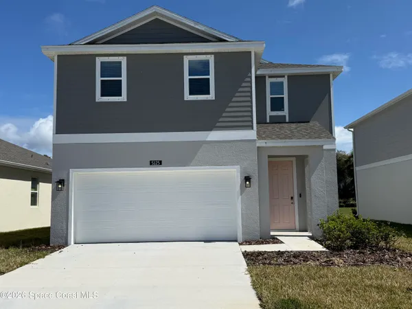 a front view of a house with garage