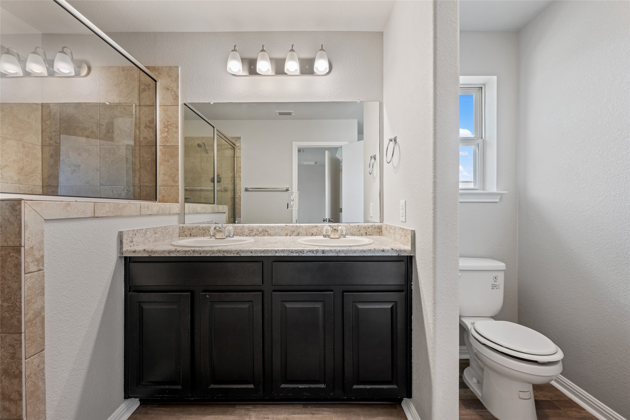 124 Guemal Road Buda, TX 78610 - Photo 31 of 40 Double vanity with ample counter space creates a functional and inviting bathroom.