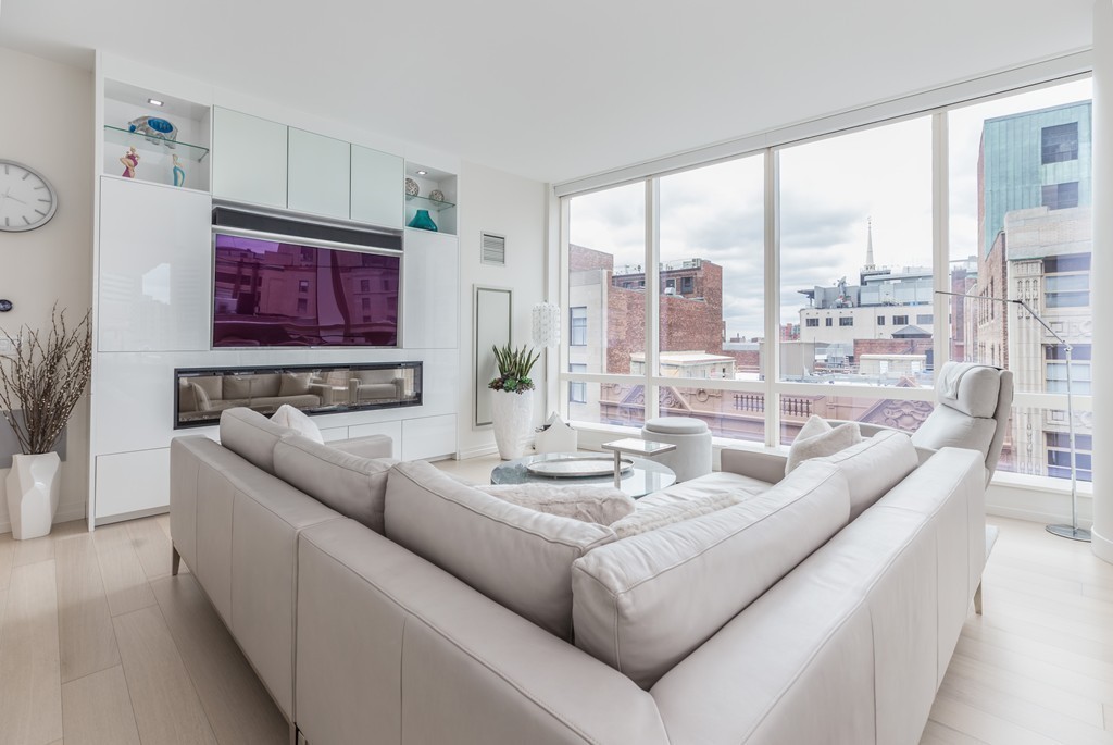 1 Franklin Street, Unit 1004 Boston, MA 02110 - Photo 11 of 24 a living room with furniture and a large window