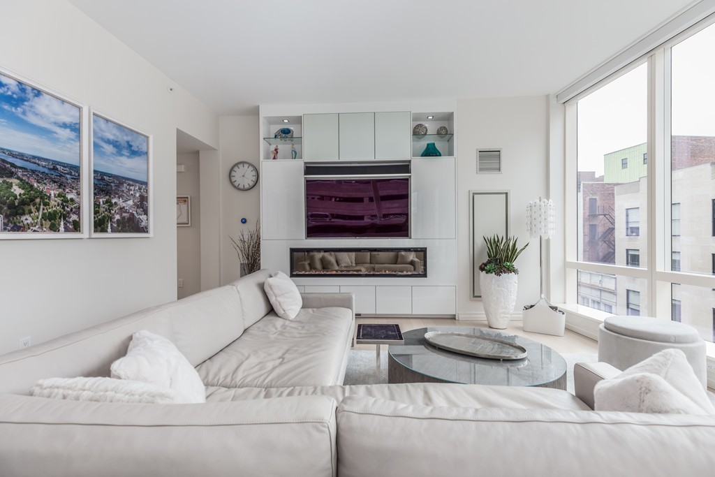1 Franklin Street, Unit 1004 Boston, MA 02110 - Photo 12 of 24 a living room with furniture and a large window