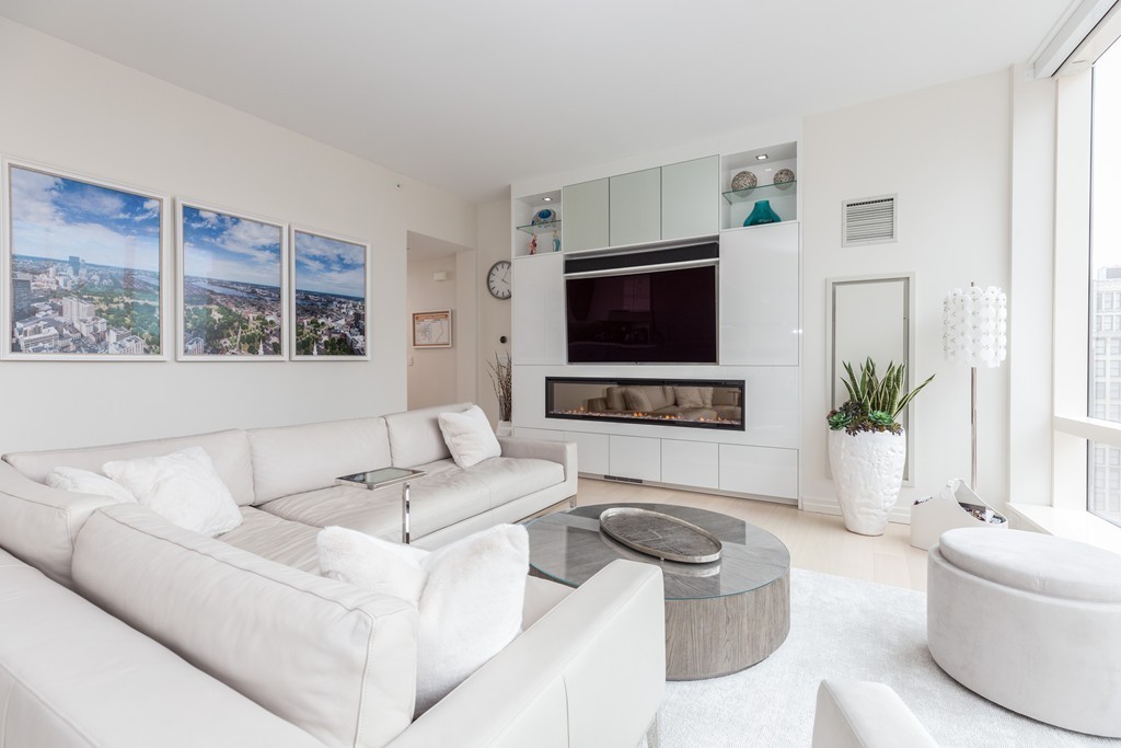 1 Franklin Street, Unit 1004 Boston, MA 02110 - Photo 13 of 24 a living room with furniture and a flat screen tv