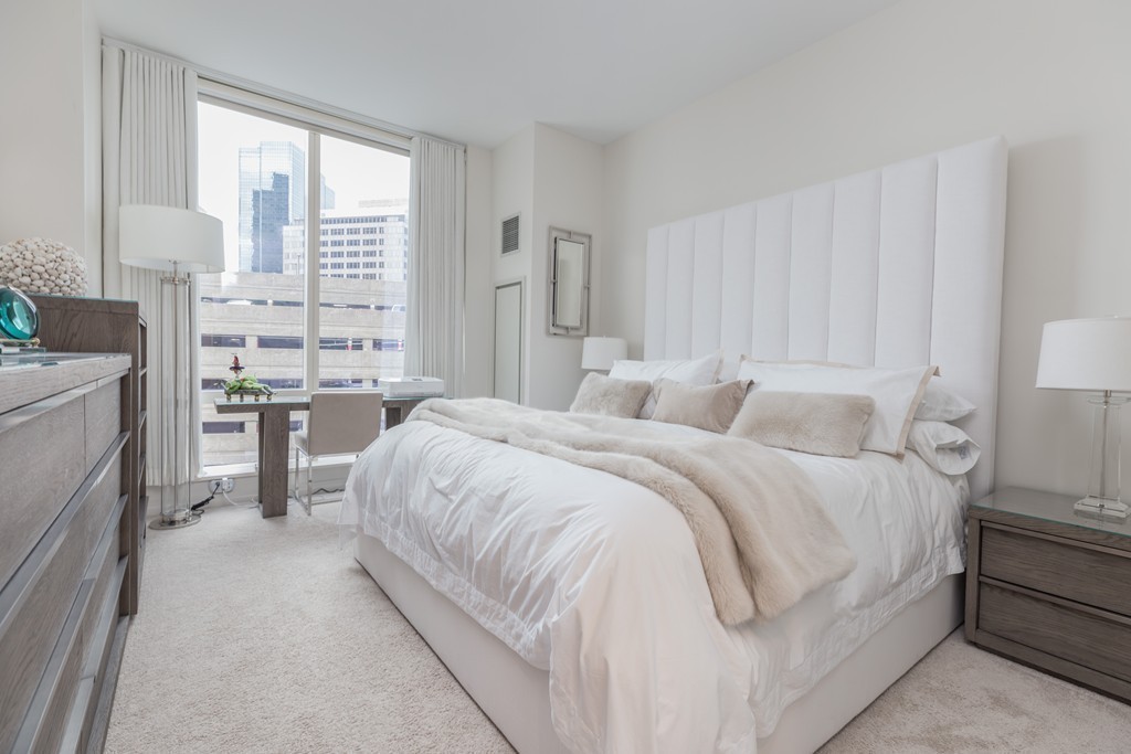 1 Franklin Street, Unit 1004 Boston, MA 02110 - Photo 15 of 24 a spacious bedroom with a bed and a cabinets