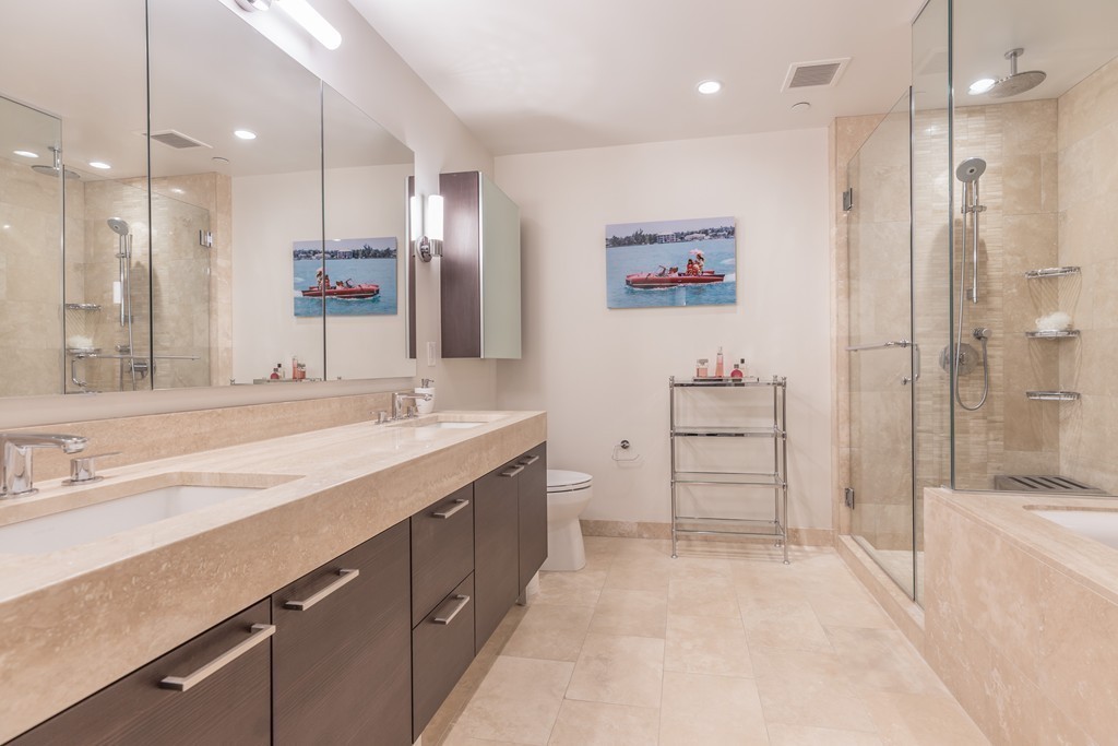 1 Franklin Street, Unit 1004 Boston, MA 02110 - Photo 18 of 24 a spacious bathroom with a sink a shower a mirror and a bathtub