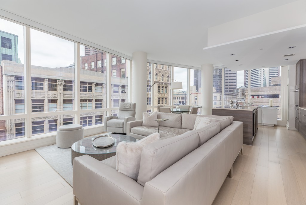 1 Franklin Street, Unit 1004 Boston, MA 02110 - Photo 2 of 24 a living room with furniture and a large window