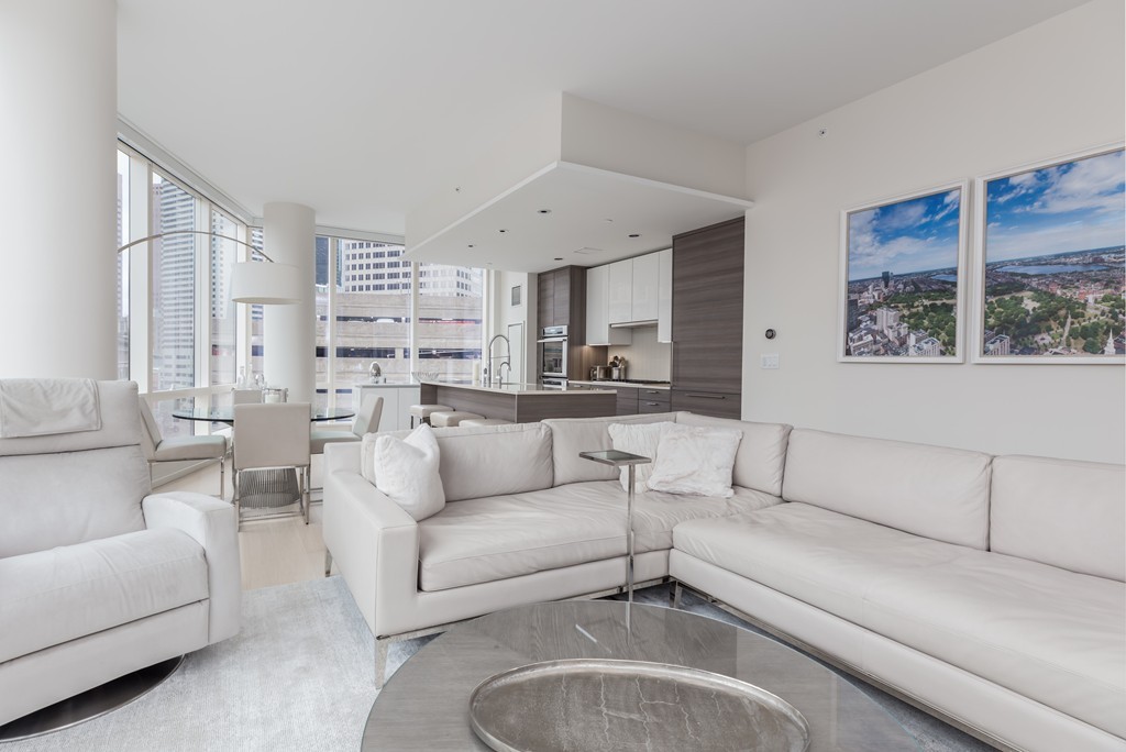 1 Franklin Street, Unit 1004 Boston, MA 02110 - Photo 3 of 24 a living room with furniture and a large window