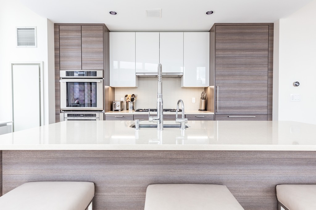 1 Franklin Street, Unit 1004 Boston, MA 02110 - Photo 8 of 24 a kitchen with a refrigerator and a sink