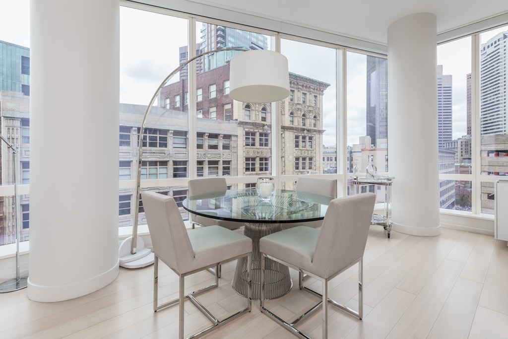 1 Franklin Street, Unit 1004 Boston, MA 02110 - Photo 9 of 24 a view of a dining room with furniture and wooden floor