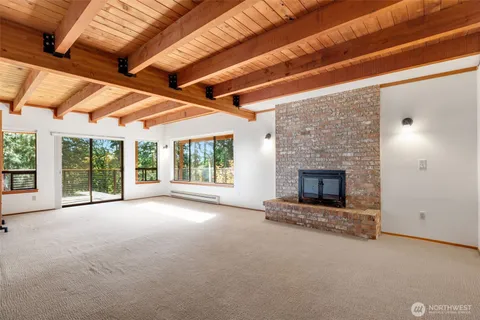 a big room with fireplace and windows