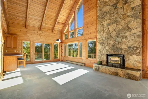 a living room with a fireplace furniture and a large window