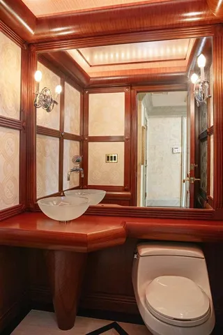 a bathroom with a toilet a sink and a mirror