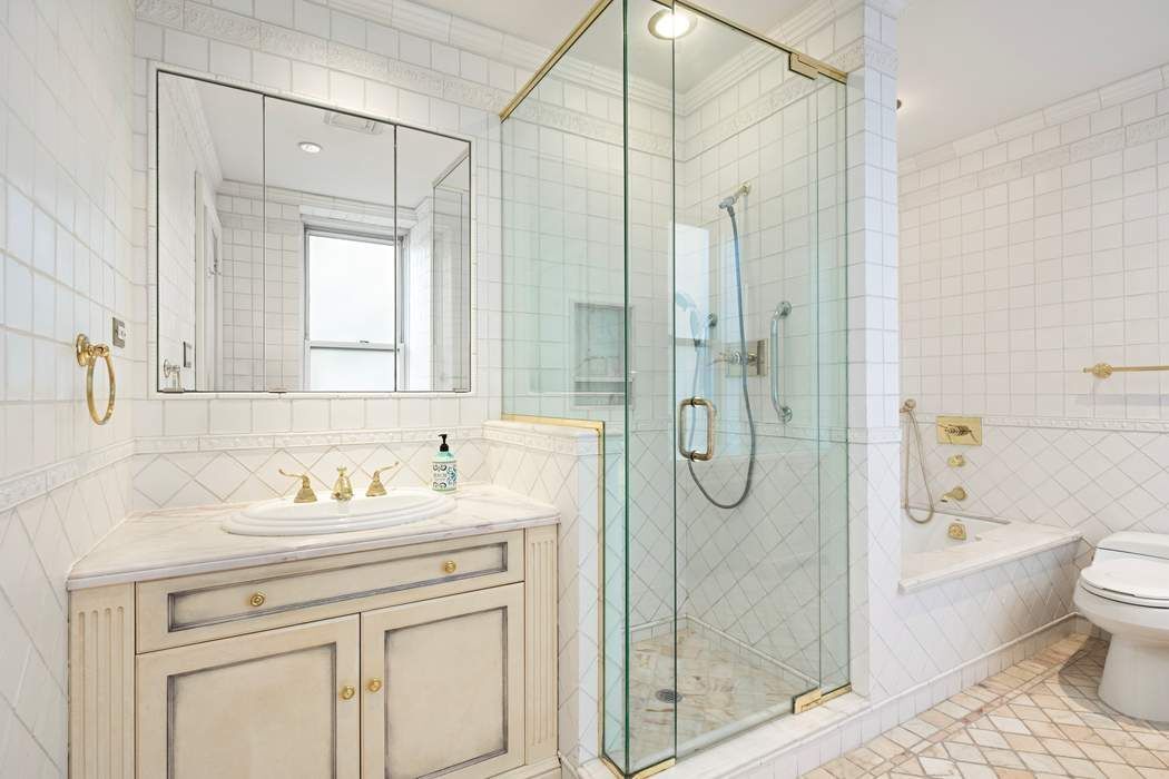 1040 5th Avenue, Unit 3A Manhattan, NY 10028 - Photo 13 of 16 a bathroom with a granite countertop sink a toilet and shower