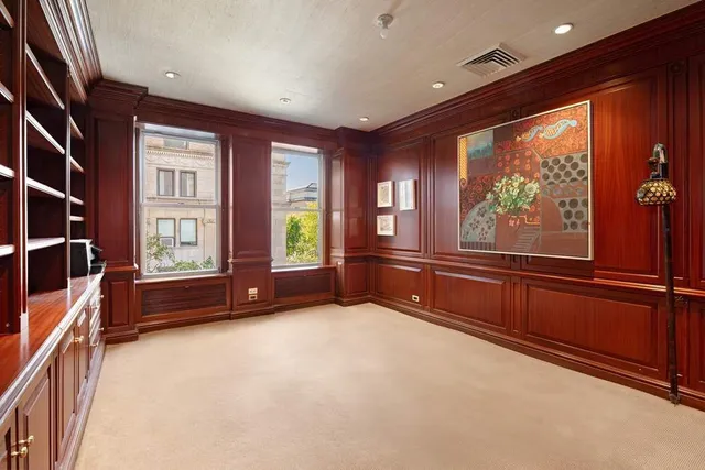 a living room with furniture and large windows
