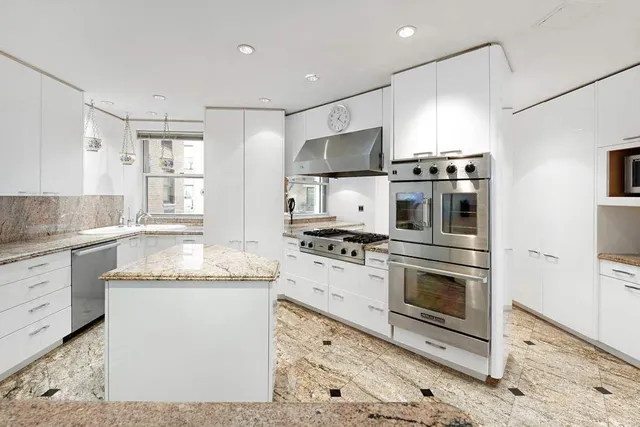 a kitchen with stainless steel appliances granite countertop a stove a sink and a refrigerator
