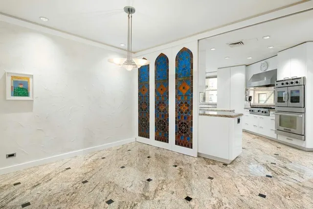 a view of a kitchen with granite countertop a refrigerator and a sink
