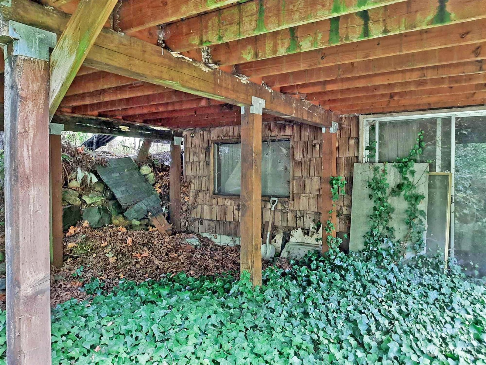 10 McKee Road Quilcene, WA 98376 - Photo 30 of 34 a view of a patio with table and chairs under an umbrella