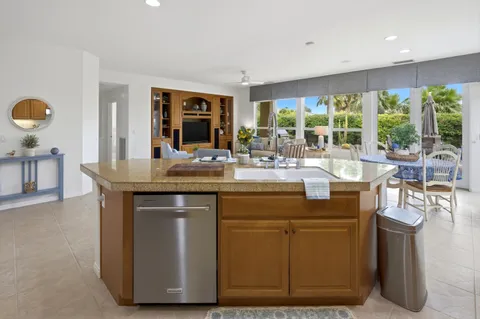 a dining hall with granite countertop a stove and chairs