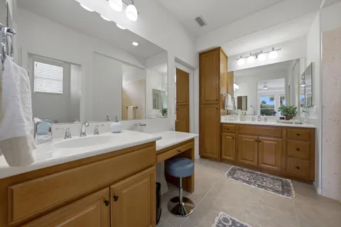 a spacious bathroom with a granite countertop sink mirror and double