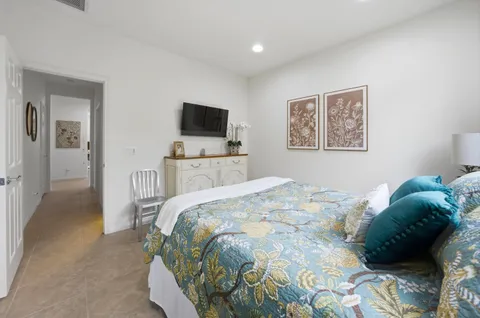 a bedroom with a bed and a television