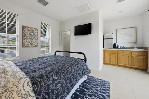 a bedroom with a bed and a flat screen tv