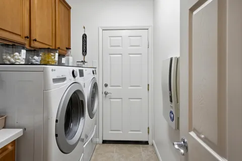 a view of a hallway with washer and dryer