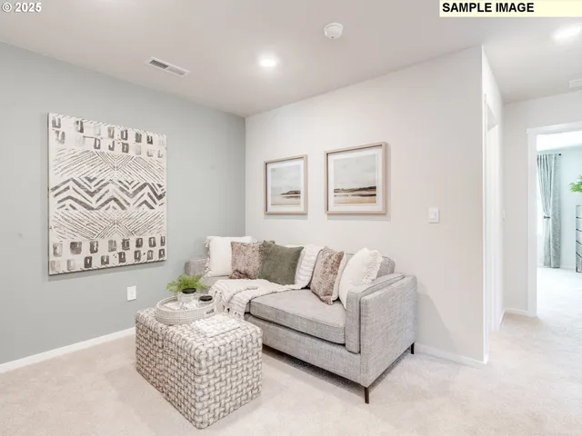 a living room with furniture and a wall painting