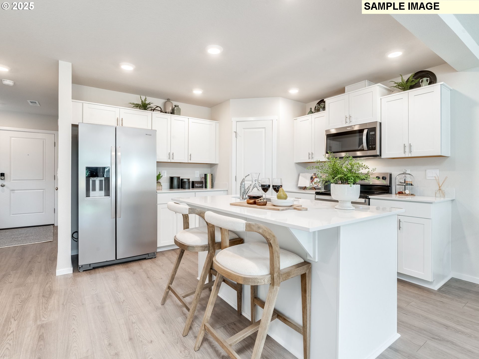 11204 Southeast Maxon Road Vancouver, WA 98664 - Photo 5 of 30 a kitchen with a sink a microwave a refrigerator and cabinets